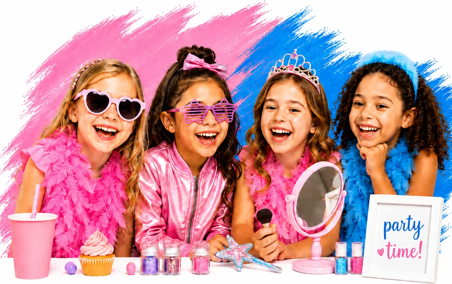 Four girls laughing at a salon party table with feather boas, tiaras, glitter, a mirror, a cupcake and a 